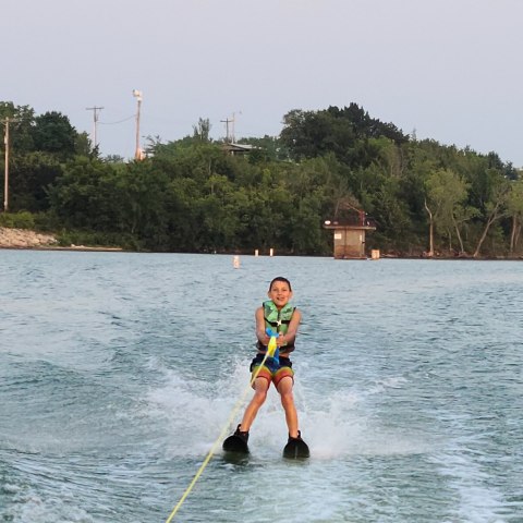 a man water skiing on a lake