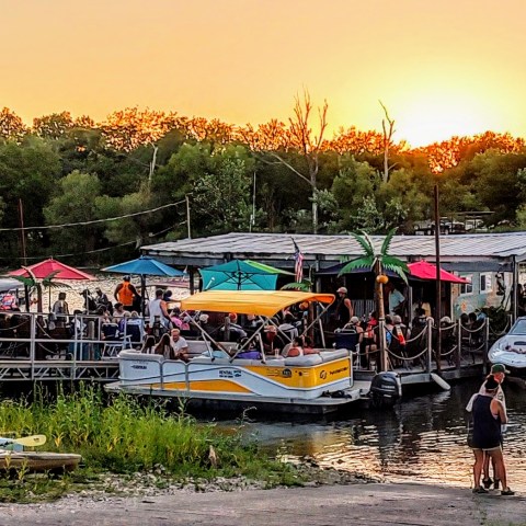 a group of people in a small boat in a harbor