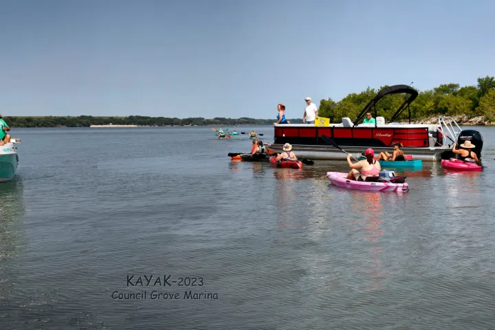 a group of people in a small boat in a body of water