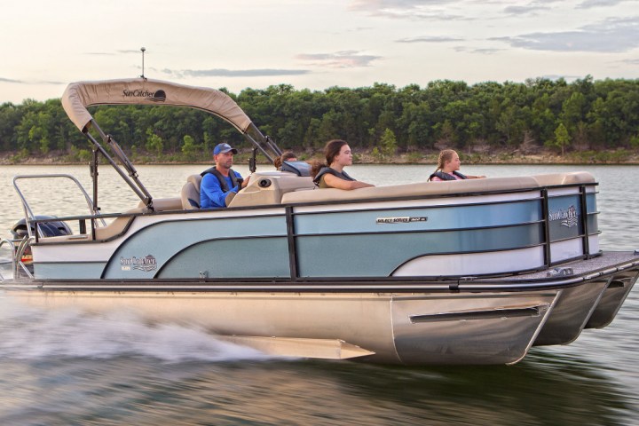 a group of people in a small boat in a body of water