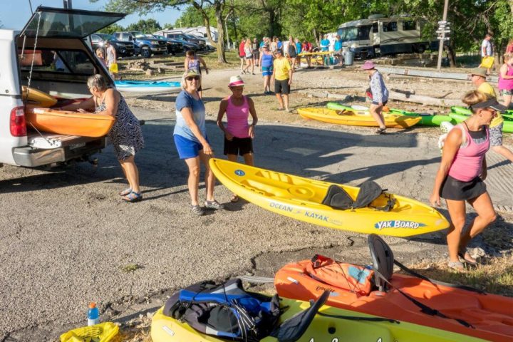 a woman sitting on a raft in the sand