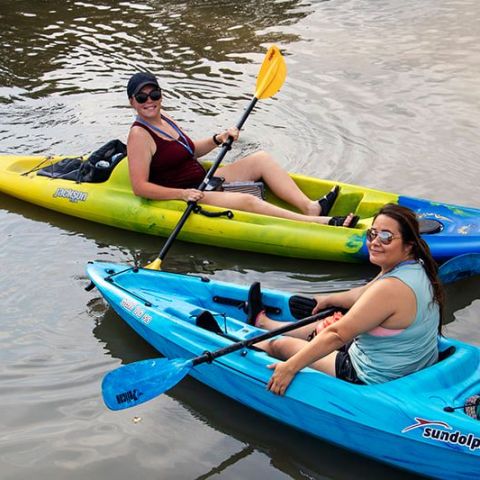 a person in a blue boat sitting next to a body of water