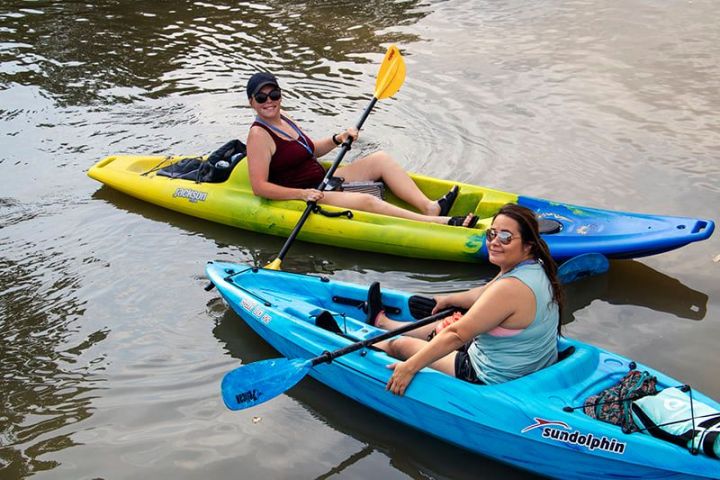a person in a blue boat sitting next to a body of water