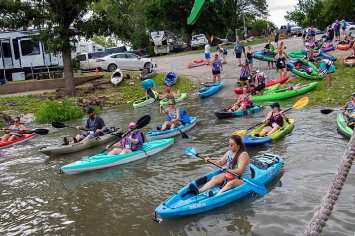 a group of people riding on kayaks