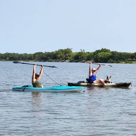 a group of people rowing a boat in a body of water