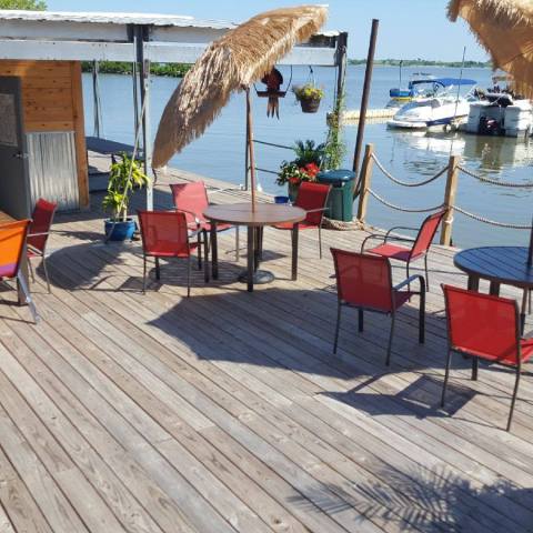 a group of people sitting at a table with an umbrella