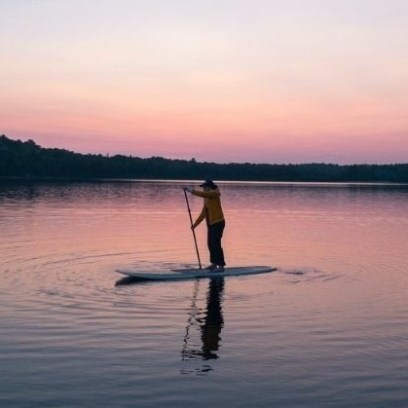 a person standing next to a body of water