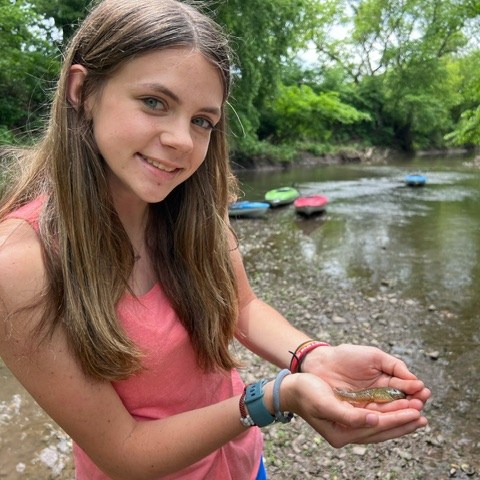 a person standing next to a river