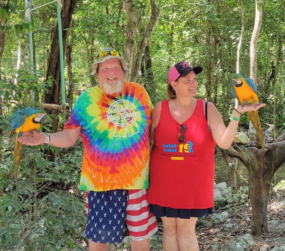 a person standing next to a forest